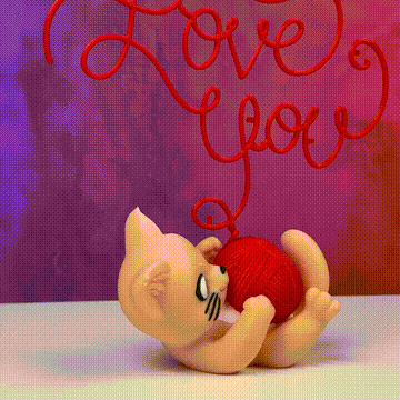 Gatito jugando con ovillo que forma Love You